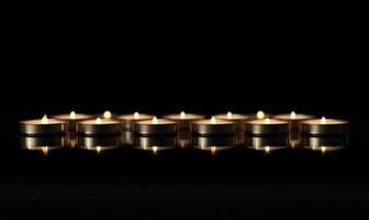 A row of candles are lit up and are reflected in the water photo
