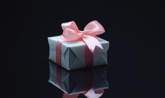 A white box with a pink ribbon on top photo