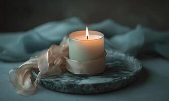 A candle is lit on a table photo