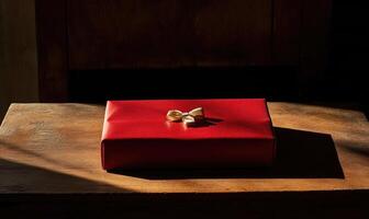 A red box with a bow on top of it photo