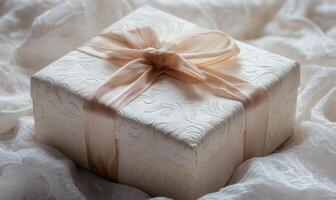 A white box with a bow on top photo