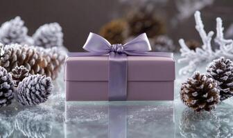 A box with a purple bow on top of a table with pine cones photo
