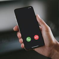 Hand holds smartphone, incoming call from unknown number, blurred background For Social Media Post Size photo