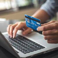Typing on laptop with credit card, emphasizing digital transaction and online purchase For Social Media Post Size photo