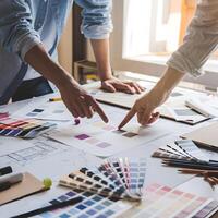 Creative collaboration, workspace with color swatches, blueprints, natural light streaming. For Social Media Post Size photo