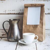 Wooden surface with white cup, metallic pitcher, and brown paper bag, rustic feel For Social Media Post Size photo