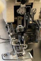 Detailed view of a sewing machine in action at a textile workshop photo