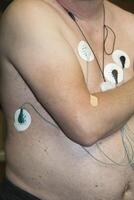Patient undergoing electrocardiogram testing in a medical facility photo