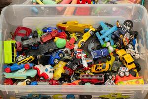 Colorful collection of toy cars and vehicles in a storage container photo