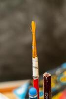 Brushes and colors arranged on a creative workspace for painting photo