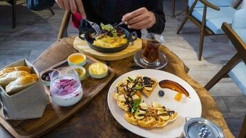 Enjoying a delicious breakfast spread with fresh ingredients and herbal tea photo