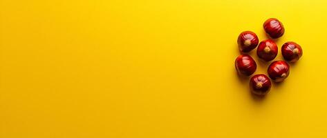 A Cluster of Fresh and Ripe Red Apples on a Vibrant Yellow Background photo
