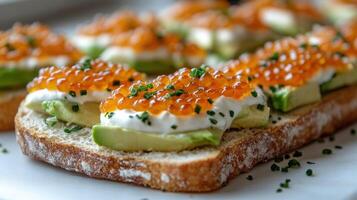 An open-faced sandwich features fresh avocado and vibrant fish roe, inviting indulgence photo