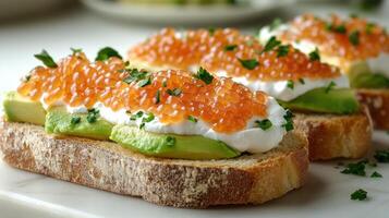 Avocado toast with salmon roe and herbs sits invitingly on a rustic table photo