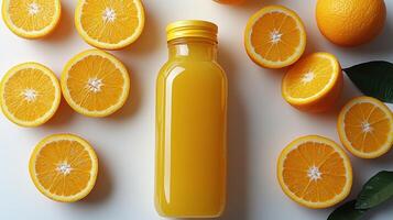 A vibrant bottle of orange juice sits among freshly sliced oranges, a true tropical delight photo