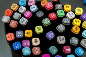 Collection of colorful markers arranged in a circular pattern photo