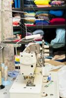 Sewing machine setup in a colorful fabric workshop photo