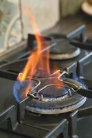 Flame flickering on a gas stove burner in a kitchen setting photo