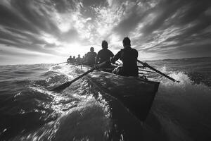 A black and white image of a rowing crew powerfully navigating choppy ocean waves towards a dramatic, sunlit sky photo