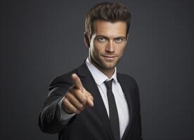 A well dressed man in a dark suit extends his index finger towards the viewer, conveying confidence and direct engagement photo