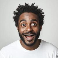 Closeup portrait of a surprised young Black man with a joyful expression. His wearing a plain white t shirt against a neutral background photo
