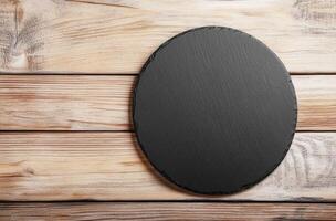 Rustic Black Slate Round Serving Board on Wooden Table photo