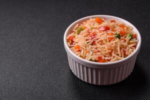 Boiled rice with vegetables, salt and spices photo