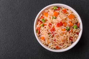 Boiled rice with vegetables, salt and spices photo