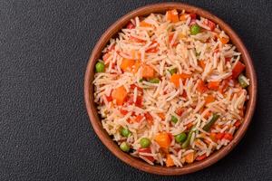 Boiled rice with vegetables, salt and spices photo