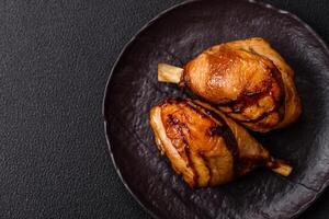 Delicious grilled chicken legs with spices and herbs in teriyaki sauce photo