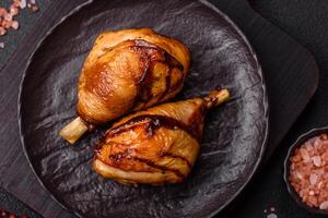 Delicious grilled chicken legs with spices and herbs in teriyaki sauce photo