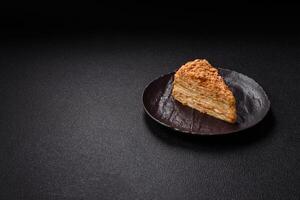 Piece of sweet layer cake Napoleon with custard photo