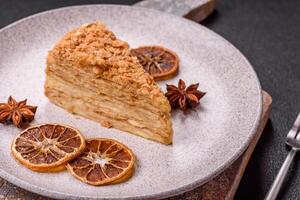 Piece of sweet layer cake Napoleon with custard photo