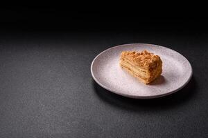Piece of sweet layer cake Napoleon with custard photo