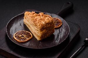 Piece of sweet layer cake Napoleon with custard photo