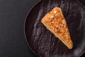 Piece of sweet layer cake Napoleon with custard photo