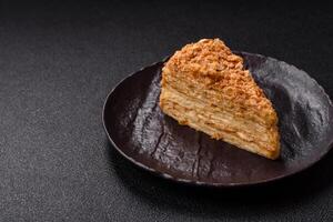 Piece of sweet layer cake Napoleon with custard photo