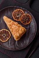 Piece of sweet layer cake Napoleon with custard photo