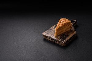 Piece of sweet layer cake Napoleon with custard photo