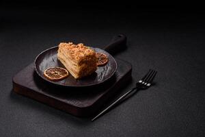 Piece of sweet layer cake Napoleon with custard photo