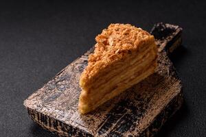 Piece of sweet layer cake Napoleon with custard photo