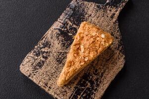 Piece of sweet layer cake Napoleon with custard photo