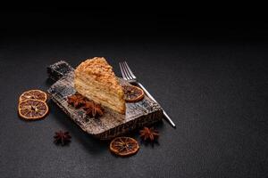 Piece of sweet layer cake Napoleon with custard photo