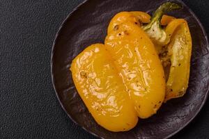 Yellow sweet pepper cut in half and grilled with salt, spices and herbs photo