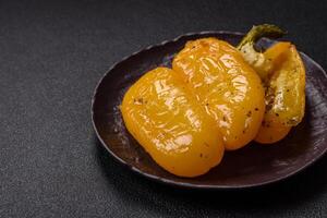 Yellow sweet pepper cut in half and grilled with salt, spices and herbs photo