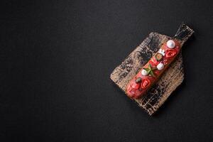 Sweet eclair with chocolate filling, decorated for Christmas photo