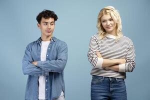 Portrait of smiling couple, boyfriend and girlfriend wearing casual clothes with crossed arms photo