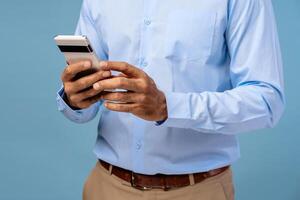 Closeup, businessman holding mobile phone, using mobile app selective focus on hands photo