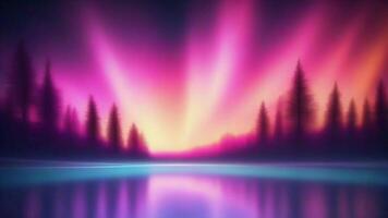 Silhouetted trees with vibrant pink and purple aurora borealis reflected in a still lake. photo