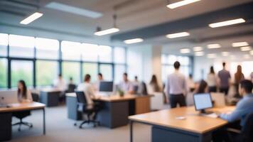 Blurred background of a modern office with people working at desks. photo
